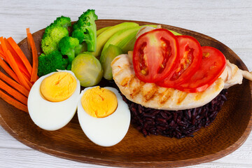Clean food, Riceberry Rice and chicken with vegetables on  wood background