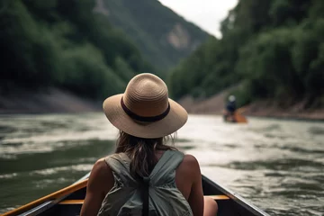 Foto op Canvas Woman in hat resting in boat on water in hills, enjoying nature. Rafting on river, kayaking vacation. Rear view, close-up. Generative AI © Sergio