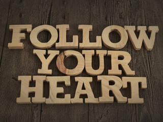 Follow your heart, text words typography written with wooden letter, life and business motivational inspirational