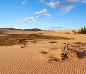 Fototapeta na wymiar Sand dunes near mui ne. group of off roads on top of dunes in background. sunny day with blue sky.