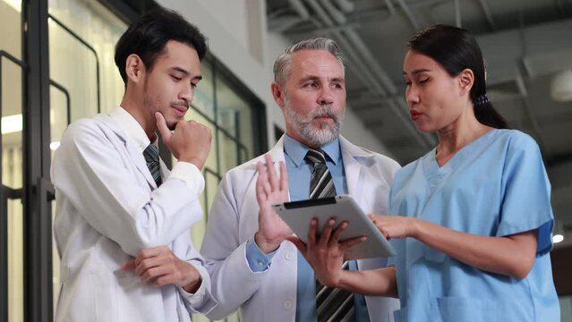 Professional medical staff people successful and teamwork concept. Diverse doctor and nurse meeting and talking discussion on teblet together at hospital medical wellness center