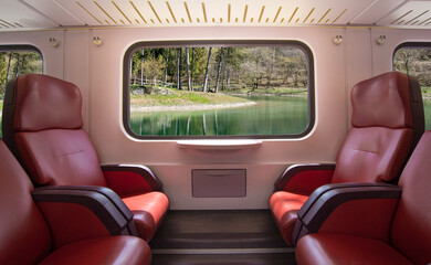 the train passes in the mountains in front of an alpine lake