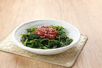 Plecing Kangkung or Brambang Asem, made from boiled spinach served with chili sauce (sambal), spicy and sour. Indonesian food
