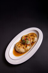 local steam grilled cook live fresh chilean seabass cod fish fillet in Hong Kong style soy sauce on black background asian Chinese banquet halal seafood steamboat menu 
