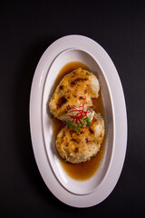 local steam grilled cook live fresh chilean seabass cod fish fillet in Hong Kong style soy sauce on black background asian Chinese banquet halal seafood steamboat menu 