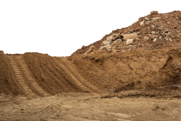Isolate mounds of sand and concrete debris that have been excavated and poured together with backhoe wheels to prepare materials for filling and repairing roads in rural Thailand during the dry season