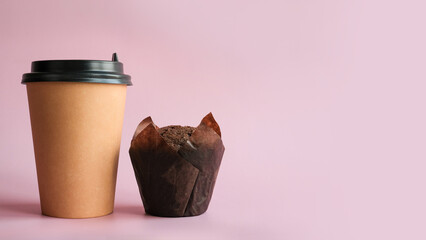 Chocolate muffin and paper coffee cup close-up with a place for text