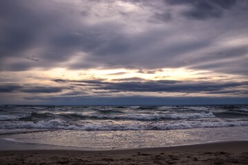 Cloudy winter seaside landscape. Cloudy day on the beach in Gdynia, Poland.