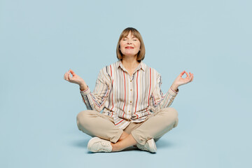 Full body elderly woman 50s years old wear shirt hold spreading hands in yoga om aum gesture relax...