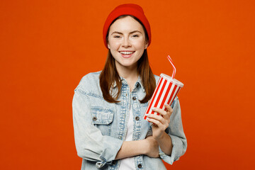 Young smiling cheerful fun woman wear denim shirt white t-shirt red hat look camera hold in hand...