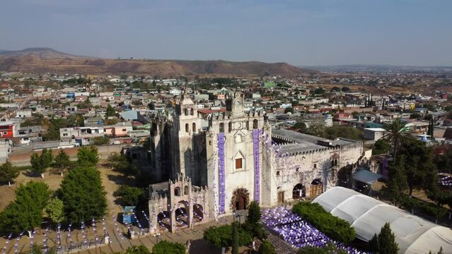 aerial view of old church in mexico in jacaranda season