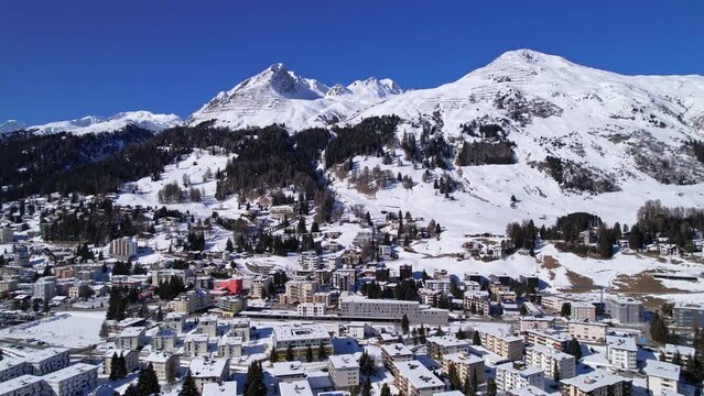 Sunny day over the residential area in the Swiss Alps. Davos, Switzerland, Aerial cinematic landscape