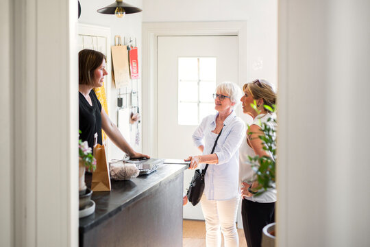 Guests talking with hotel receptionist