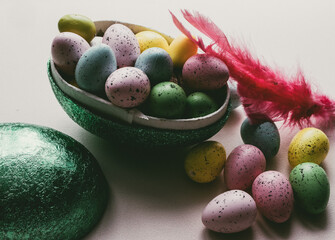 Ester egg filled with Easter sweets in green, blue, yellow and pink