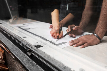 Man and woman working with blueprint