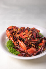 local wok fried Sri Lanka big fresh live crab with spicy onion garlic chilli salted egg yolk white pepper sauce vermicelli on wood table asian chinese halal food banquet seafood menu for restaurant