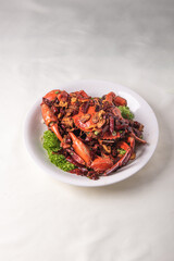 local wok fried Sri Lanka big fresh live crab with spicy onion garlic chilli salted egg yolk white pepper sauce vermicelli on wood table asian chinese halal food banquet seafood menu for restaurant