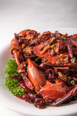 local wok fried Sri Lanka big fresh live crab with spicy onion garlic chilli salted egg yolk white pepper sauce vermicelli on wood table asian chinese halal food banquet seafood menu for restaurant