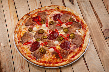 tasty pizza on the wooden background