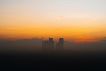 Fototapeta na wymiar Golden sunrise near the skyscraper building.