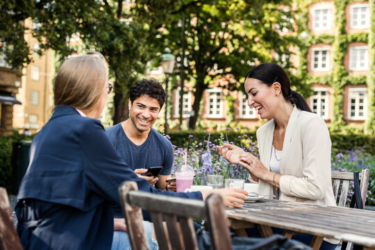 Friends spending time in sidewalk cafe