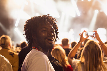 Man smiling at music concert