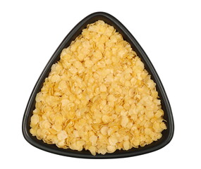 Millet flakes in porcelain bowl isolated on white, top view