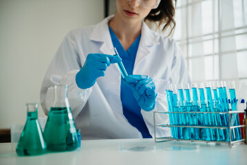 Modern medical research laboratory. female scientist working with micro pipettes analyzing...