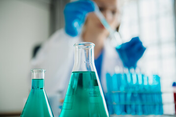 Modern medical research laboratory. female scientist working with micro pipettes analyzing...