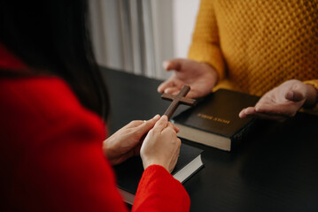 Obraz premium Christians are congregants join hands to pray and seek the blessings of God, the Holy Bible.Study the Word of God