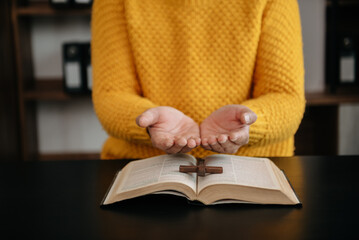 Man praying on holy bible in the morning.Woman hand with Bible praying. Christian life crisis prayer to god..