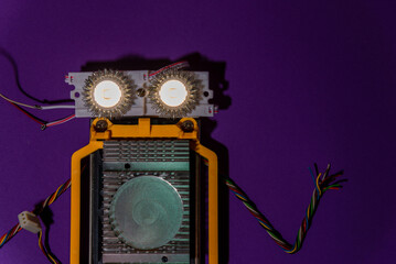Hand made robot flat lay on the arduino platform. DIY. AI. STEAM.purple background.Stem education for children and teenagers, robotics and electronics.