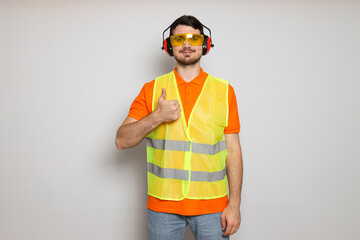 Young man civil engineer in ear protectors