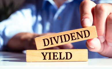 Wooden blocks with words 'DIVIDEND YIELD'. Business concept