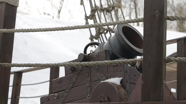 vintage cannon with wheels on the street in winter