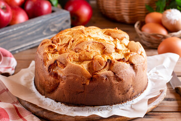 Fototapeta na wymiar Clasic sponge cake with apples on wood table. Homemade cake