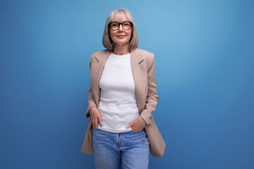 60s business woman in a jacket stands confidently on a bright background with copy space