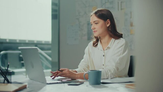 Confident Female Engineer is Typing on a Laptop Computer, Working Online on a New Project. Motivated Female Manager is Doing a New Project. Engineering and Creativity New Product Development