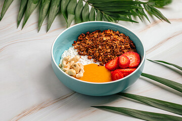 Portion of breakfast muesli bowl with strawberries and cashew