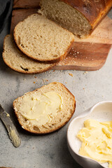 Slice of bread and butter. Closeup sourdough slice of homemade white loaf bread with butter. 