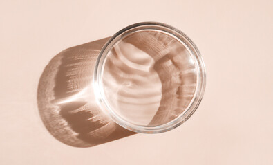 Micellar water serum texture in petri dishes on light beige background cosmetic research concept