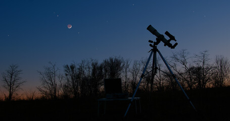 Astronomy telescope for observing stars, planets, Moon and other space objects with slightly out of focus stars on the sky.