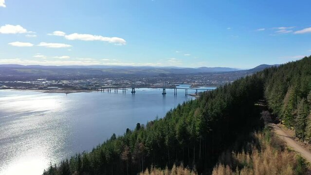 Aerial shot of coastal forest, Inverness and Kessock Bridge, Scotland