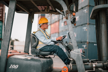 Fototapeta na wymiar Senior container controllers navigate and drive folklift to transfer, deliver and drop-off merchandise. An equitable work environment in which employees of various ages feel included and valued.