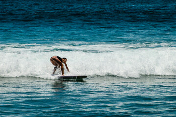 Surfers on waves, in Canggu, Bali Island, Indonesia