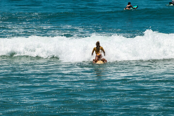 Surfers on waves, in Canggu, Bali Island, Indonesia