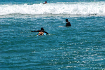 Surfers on waves, in Canggu, Bali Island, Indonesia