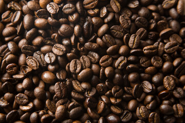 Coffee beans occupying the entire frame of a photograph.
