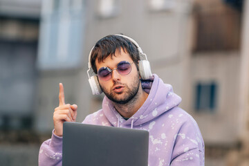 dj man with laptop on street