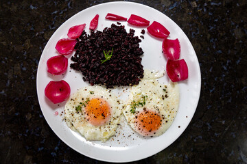 Traditional Brazilian recipe black rice with eggs and pickled onions